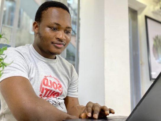 photo of man looking at laptop